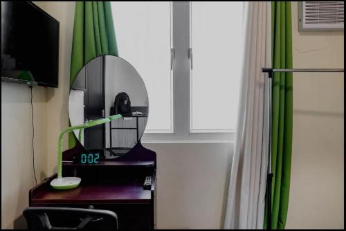 a mirror sitting on a desk in a room at A Refreshing Condo Unit Near BGC, Ortigas & Makati with NETFLIX and WiFi in Manila