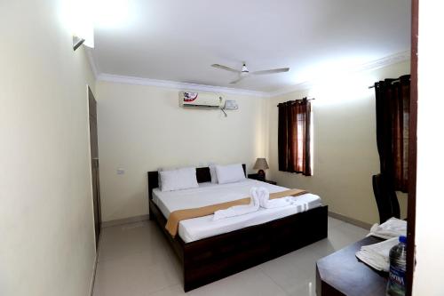 a bedroom with two beds with towels on them at Chetinaad Courtyard Gandhipuram by Centre Park in Coimbatore