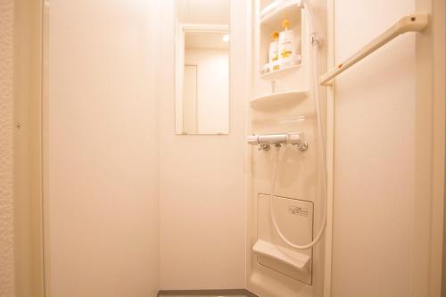 a small bathroom with a shower and a toilet at SEVEN Building / Vacation STAY 4946 in Asahikawa