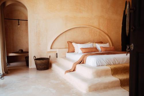 a bedroom with a large bed with an arched ceiling at The Oasis Bali in Canggu
