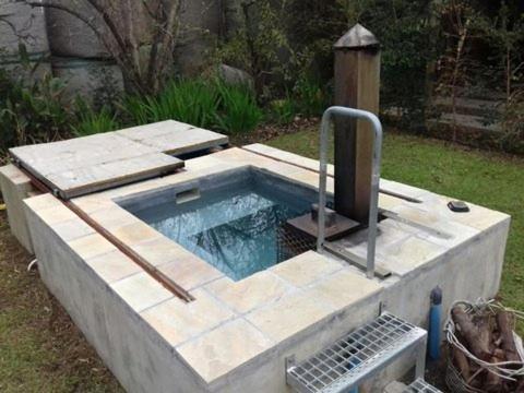 a swimming pool with a fountain in a yard at Bergsicht Country Farm Cottages in Tulbagh