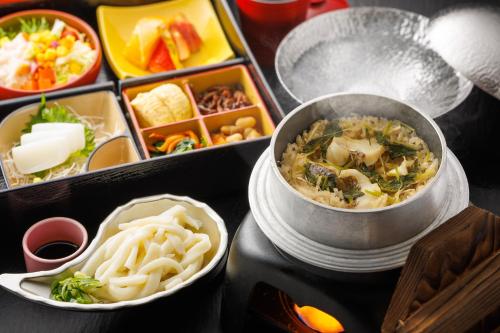 a tray of food with a bowl of soup and pasta at Luxury Trailers 離宮 伊勢 in Sōchi