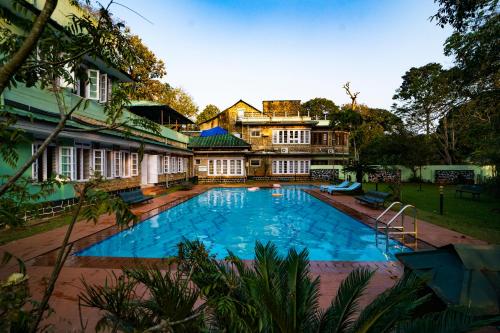 a large swimming pool in front of a house at Aranya Nivas in Thekkady