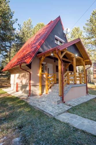 a small house with a red roof at Vila Šišarka Divčibare CENTAR in Divčibare