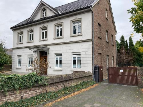 a white house with a brick building at Im alten Pastorat in Grevenbroich