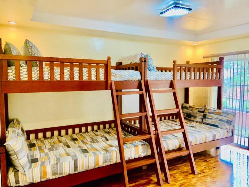 two bunk beds are in a room with at Elliannah Pines Hotel in Baguio