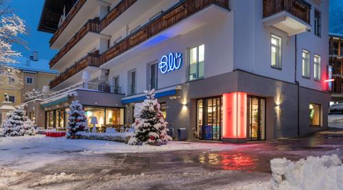 a building with christmas trees in front of it at Hotel Blü Gastein in Bad Hofgastein