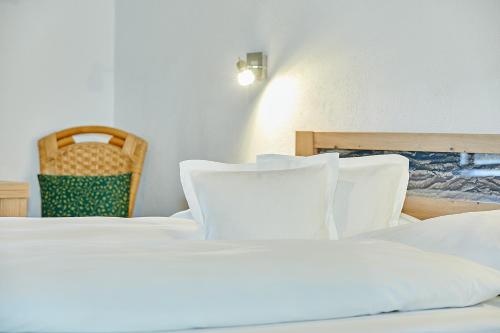 a bedroom with two beds and a chair at Haus Leiter in Reit im Winkl