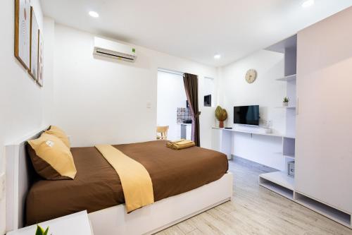 a bedroom with a large bed and a television at Ekomo Home - Central Saigon in Ho Chi Minh City