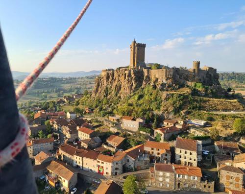 a castle on top of a hill with a city at Château de Saint Vidal in Le Puy en Velay