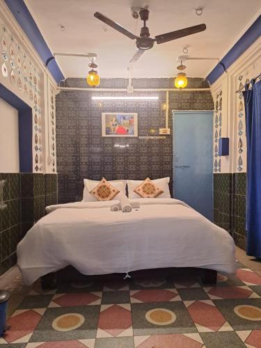 a bedroom with a large bed in a room at Dylan Cafe And Guest House in Jodhpur
