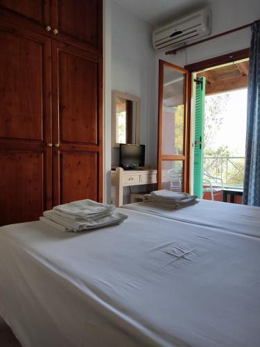 a bedroom with two beds and a large window at Villa marina apartment2 in Ipsos