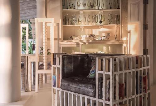 a room with a couch and shelves filled with books at W15 Escape in Ahangama