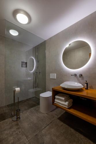 a bathroom with a sink and a toilet and a mirror at Hotel Lipa in Kranjska Gora