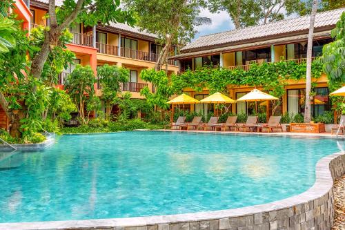 a swimming pool in front of a hotel at Buri Rasa Village Phangan in Thong Nai Pan Noi