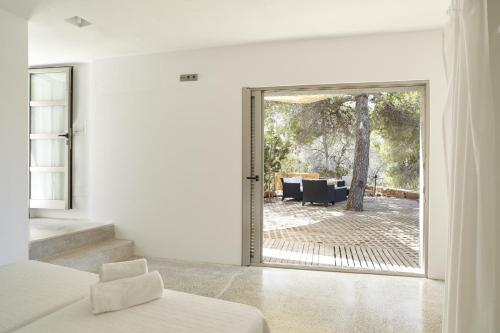 a bedroom with a large glass door leading to a patio at Villa Cosima - San Antonio in San Antonio