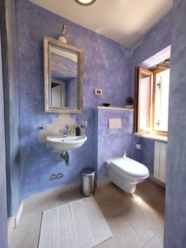 a bathroom with a sink and a toilet and a mirror at Casa Acqua Dolce - House with 4 Bedrooms and Own Spa in Oprtalj