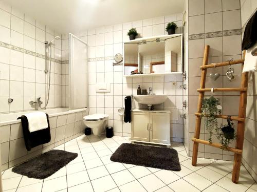 a bathroom with a sink and a toilet and a shower at Apartment DOM I - Erfurt Domplatz in Erfurt