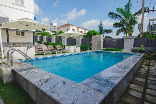 a swimming pool in the backyard of a house at BON Hotel Asokoro Residence in Abuja