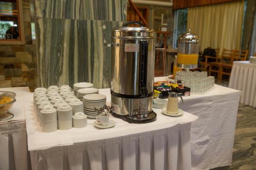 a table with a blender and cups on it at Hotel Liberty in Mesolongion