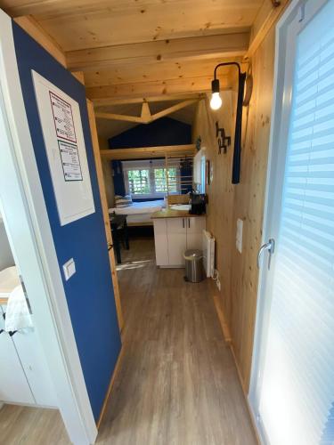 a hallway in a tiny house with a blue wall at Tiny House Möhne im PIER9 Tiny House Hotel in Hamm