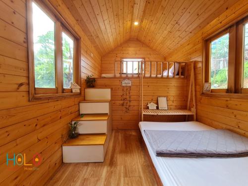 a room with two beds in a wooden cabin at Les Bois BaVi by HOLO Serviced HomeStay in Hanoi