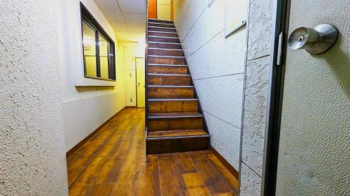 a hallway with a staircase in a building at KIYAZA River Sapporo in Sapporo