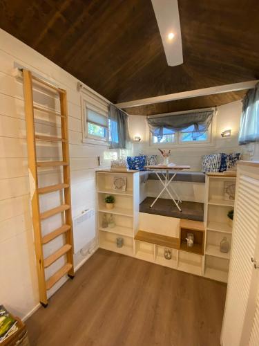 a tiny house with wooden floors and shelves in a room at Tiny House Ems im PIER9 Tiny House Hotel in Hamm