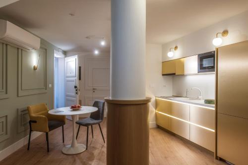 a kitchen with a table and two chairs and a table at The Blossom Collection in Heraklion City Center in Heraklio Town