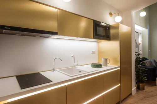 a kitchen with a sink and a microwave at The Blossom Collection in Heraklion City Center in Heraklio