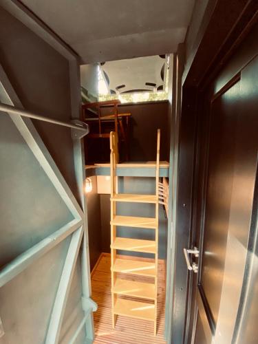 a staircase in a tiny house with a refrigerator at Tiny House Bigge im PIER9 Tiny House Hotel in Hamm