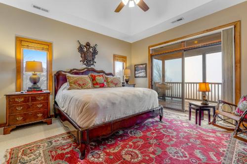 a bedroom with a large bed and a balcony at Reserve 14A in Sugar Mountain