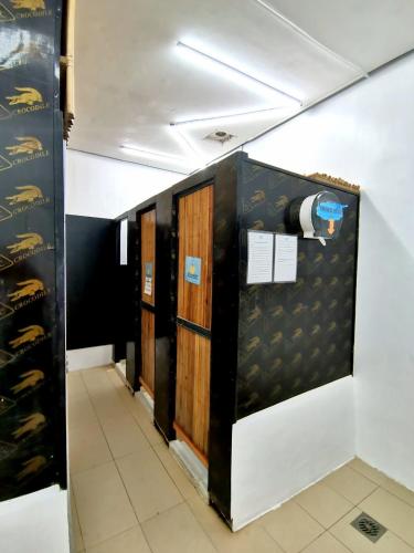a row of lockers in a room with wine bottles at Big Paul Hostel in El Nido