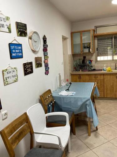 a kitchen with a blue table and chairs in a room at באר אשקלון in Ashkelon