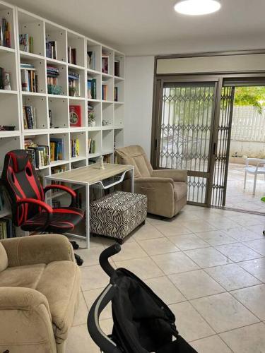 a living room with couches and a table and chairs at באר אשקלון in Ashkelon