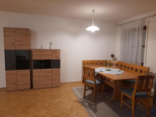 a dining room with a table and wooden chairs at Ferienwohnung Paul in Bad Reichenhall