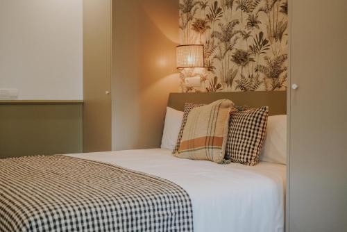 a bedroom with a bed with a blanket and pillows at Casa Los Yayos by Nomad Stays in Altea