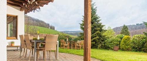 a view of a patio with a table and chairs at Ferienhaus Rothaarblick in Schmallenberg