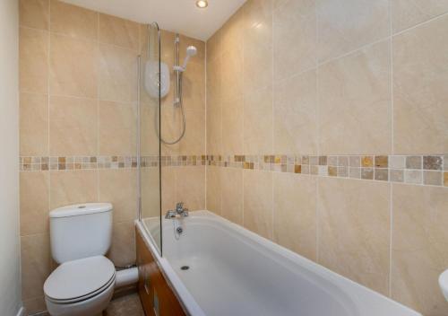 a bathroom with a tub and a toilet and a shower at Pontcanna Mews in Cardiff