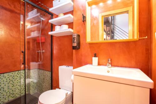 a bathroom with a toilet and a sink and a shower at Livemálaga Cervantes Attic & Terrace in Málaga