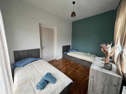 a bedroom with two beds with blue pillows on them at Helen's Art House in Pýli
