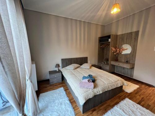 a bedroom with a bed with a stuffed animal on it at Helen's Art House in Pýli