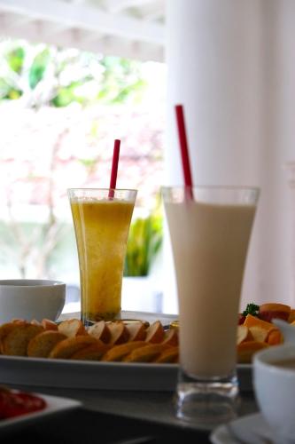 two drinks on a table with a plate of food at W15 Escape in Ahangama