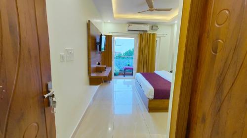 a room with a bed and a door to a bedroom at Perfectstayz Value Forest Valley Near Waterfall in Rishīkesh