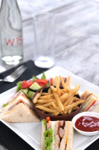a plate of food with a sandwich and french fries at W15 Escape in Ahangama