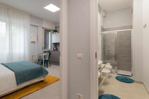 a bedroom with a bed and a bathroom at Montalbino place in Milan