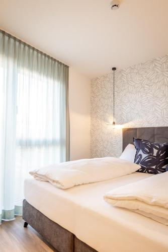 Katil atau katil-katil dalam bilik di Alp Living Apartments Self-Check In