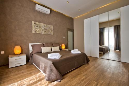 a bedroom with a large bed and a large mirror at Villa Goa - By Luxury Villas Malta in Mellieħa