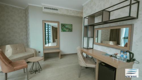 Ένα ή περισσότερα κρεβάτια σε δωμάτιο στο New Wave Hotel