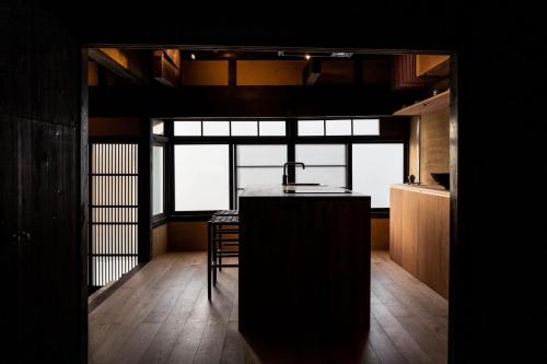 a kitchen with a island in the middle of a room at Maana Kamo in Kyoto
